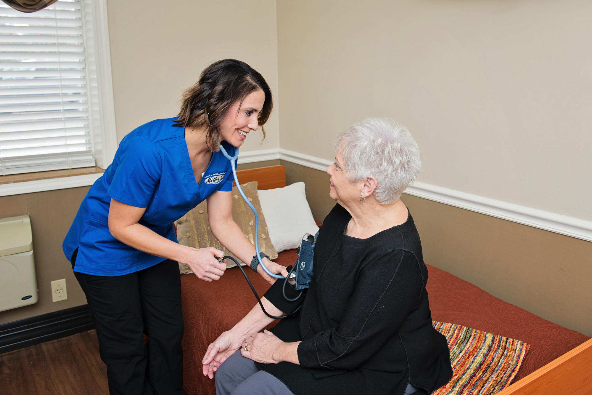 Nurse taking patient's blood pressure